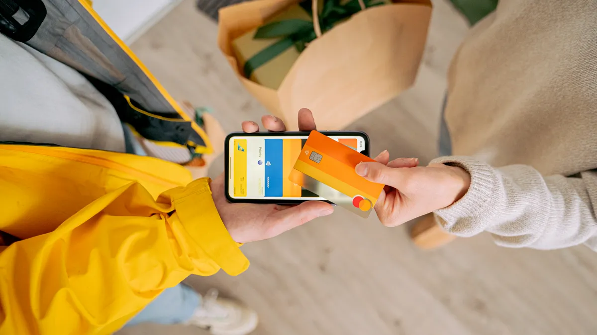 Two people exchanging digital payment cards by phone