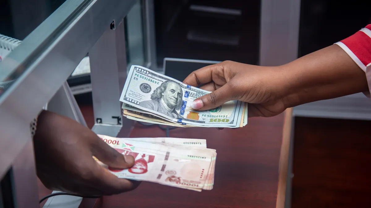 How to Sell Cryptocurrency for Cash hands exchanging cash at a counter