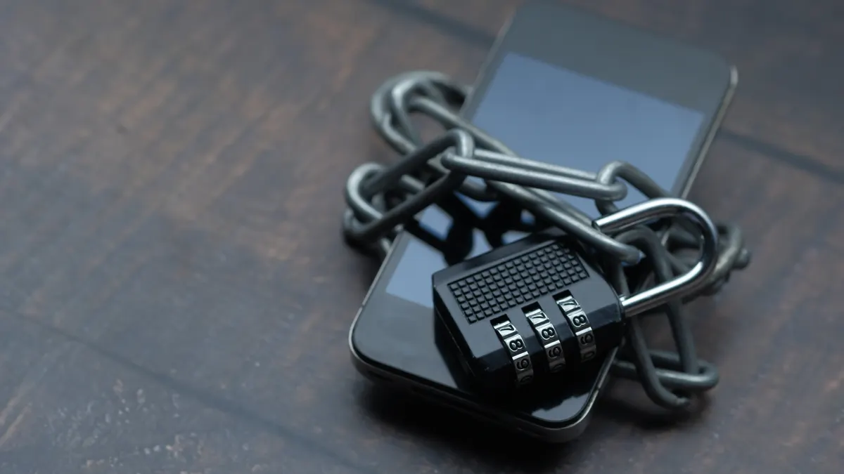 Smartphone wrapped in chain with combination lock